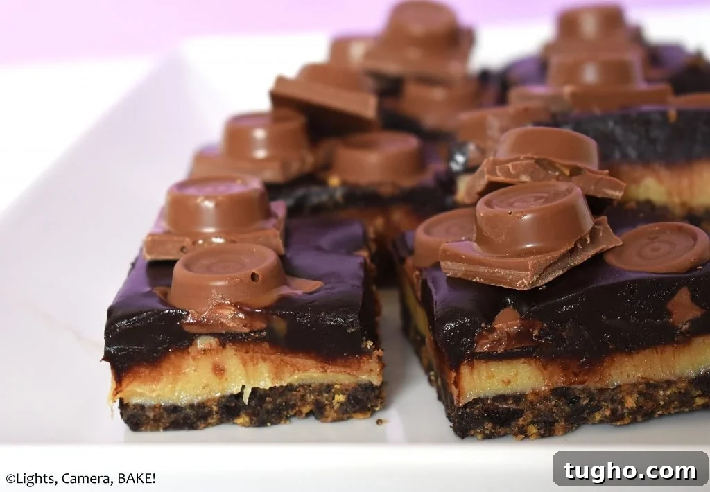 Caramel and chocolate layer slice on a white plate.