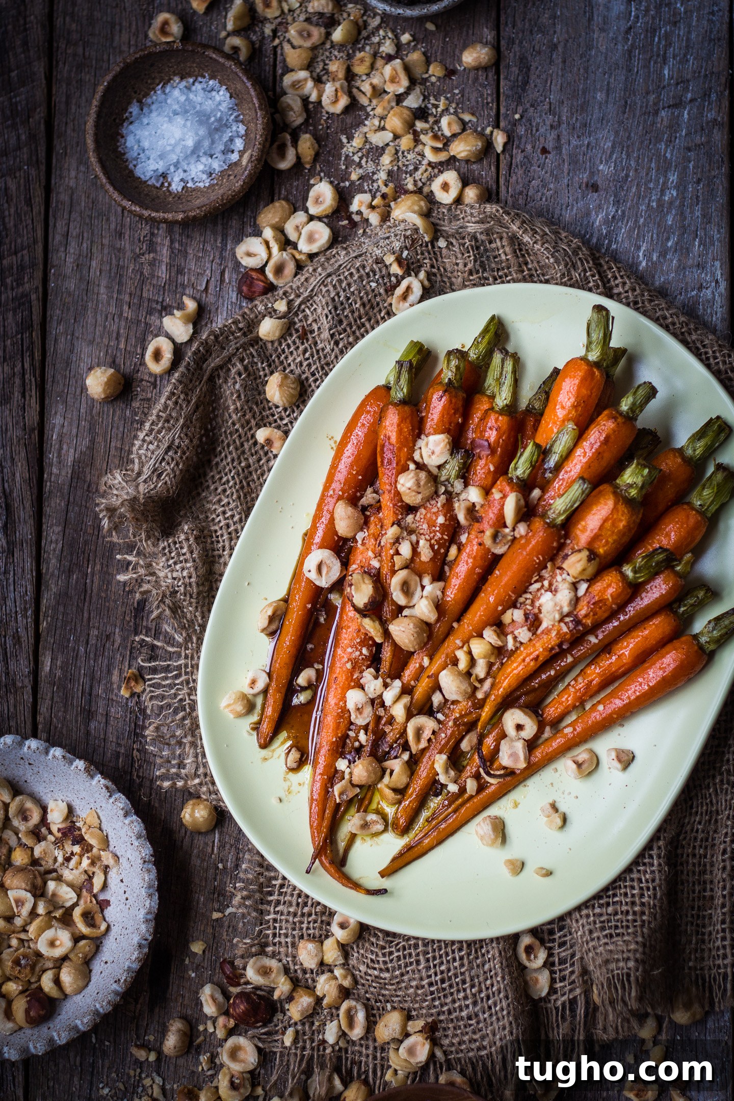 Roasted Honey Balsamic Carrots with Crushed Hazelnuts 2 Close up of honey balsamic glazed carrots topped with hazelnuts
