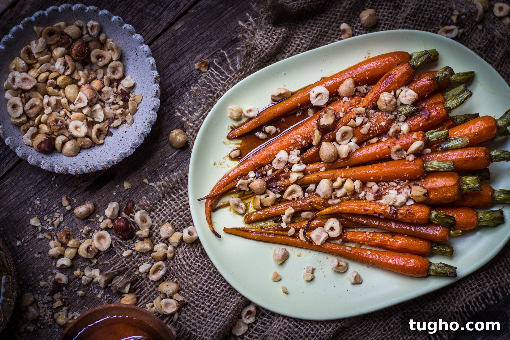 Roasted Honey Balsamic Carrots with Crushed Hazelnuts 3 Serving bowl of glazed carrots with crushed hazelnuts