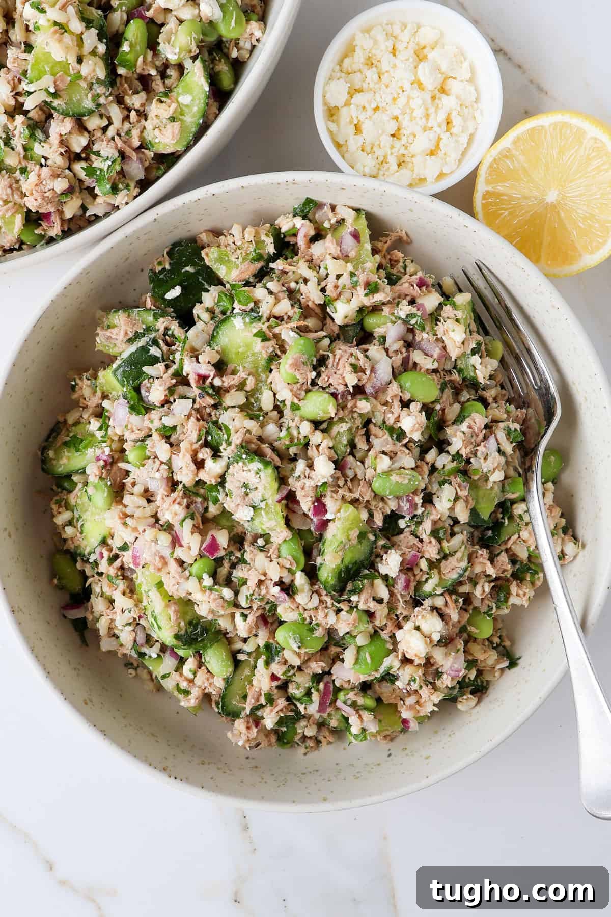 Protein-Packed Tuna, Cucumber and Edamame Salad Recipe 7 Tuna salad in a serving bowl with a fork.