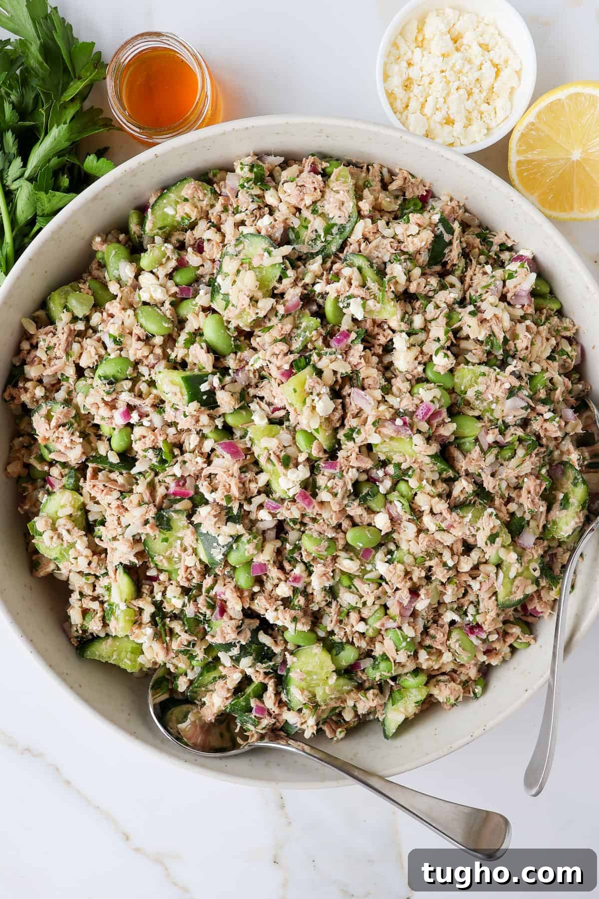 Protein-Packed Tuna, Cucumber and Edamame Salad Recipe 8 Tuna cucumber salad in a bowl with spoons.