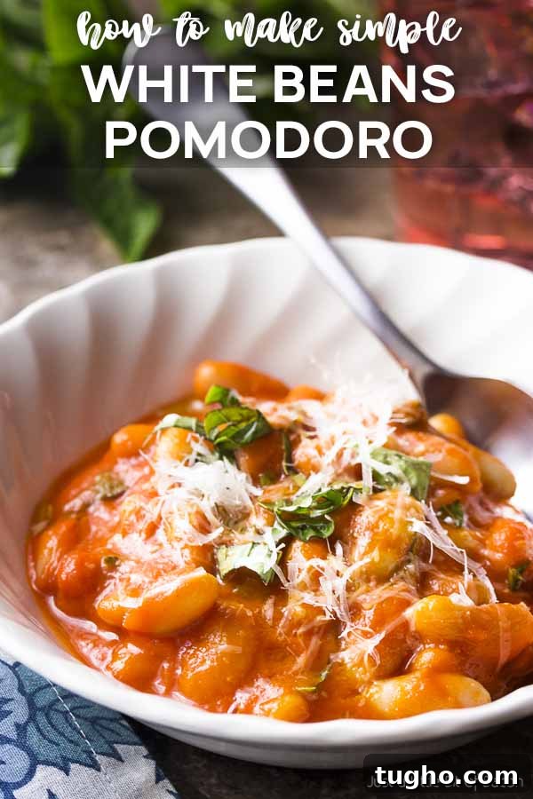 White bowl of beans in tomato sauce with text overlay - White Beans Pomodoro.
