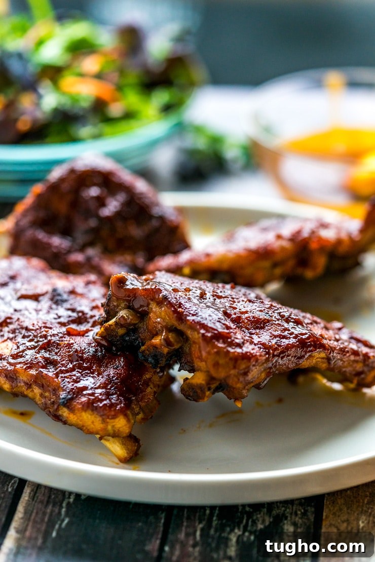 BBQ ribs made in the Instant Pot on a white plate with salad 