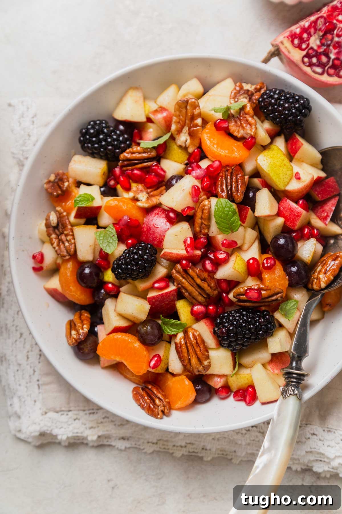 fruit salad on a bowl with a spoon.