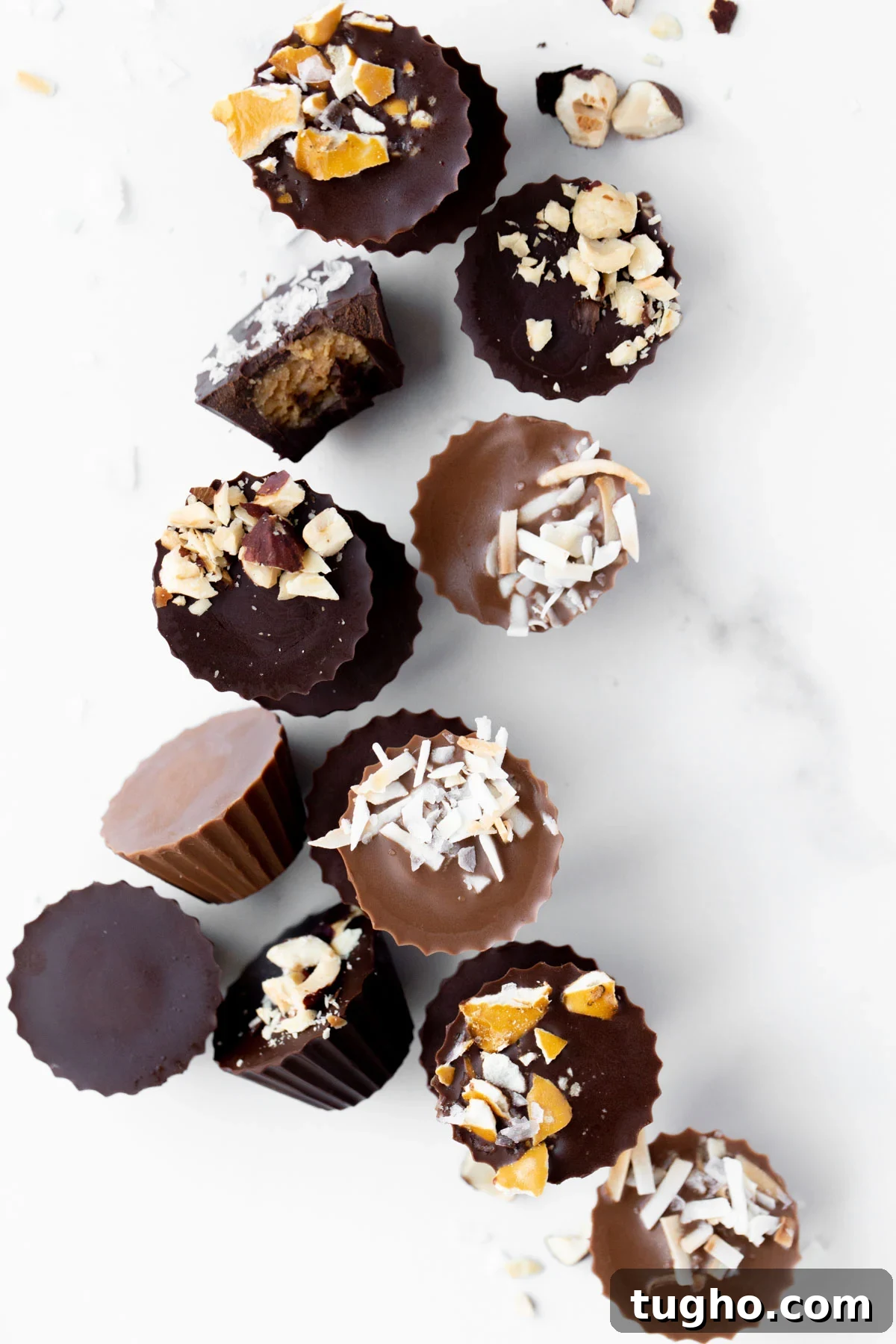 overhead photo of mini peanut butter cups topped with crushed pretzels, toasted coconut, and macadamia nuts