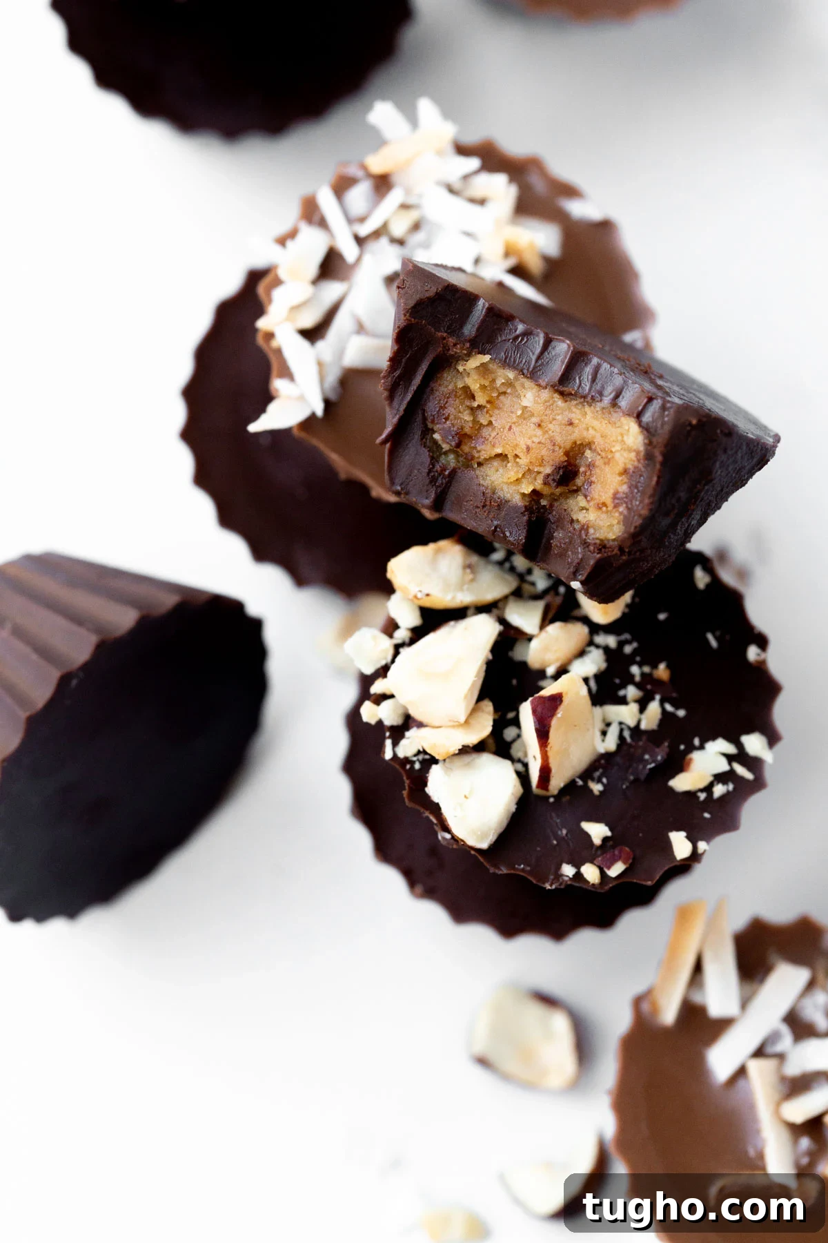 closeup of a homemade dark chocolate mini peanut butter cup with a bite taken out of it with title text overlay