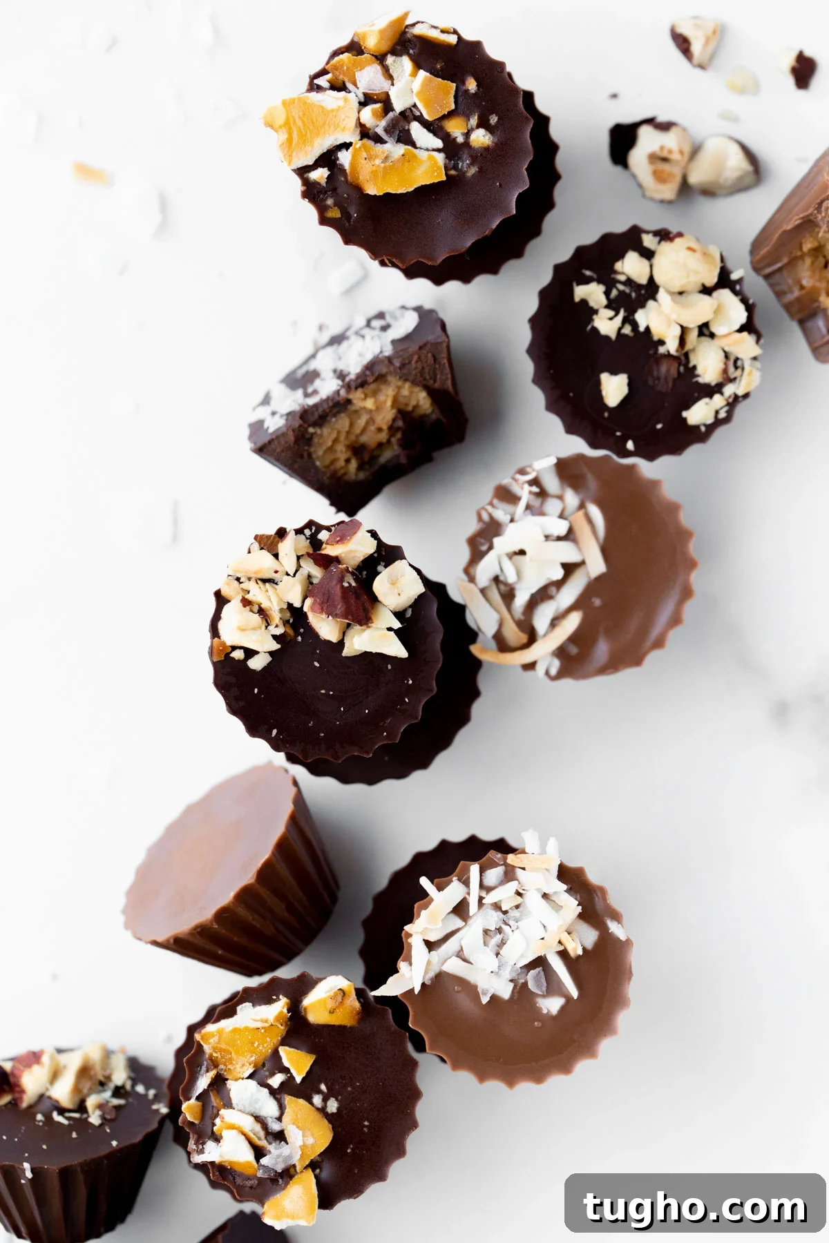 overhead photo of mini peanut butter cups topped with crushed pretzels, toasted coconut, and macadamia nuts