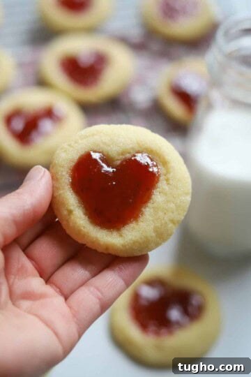 hand holding heart thumbprint cookie