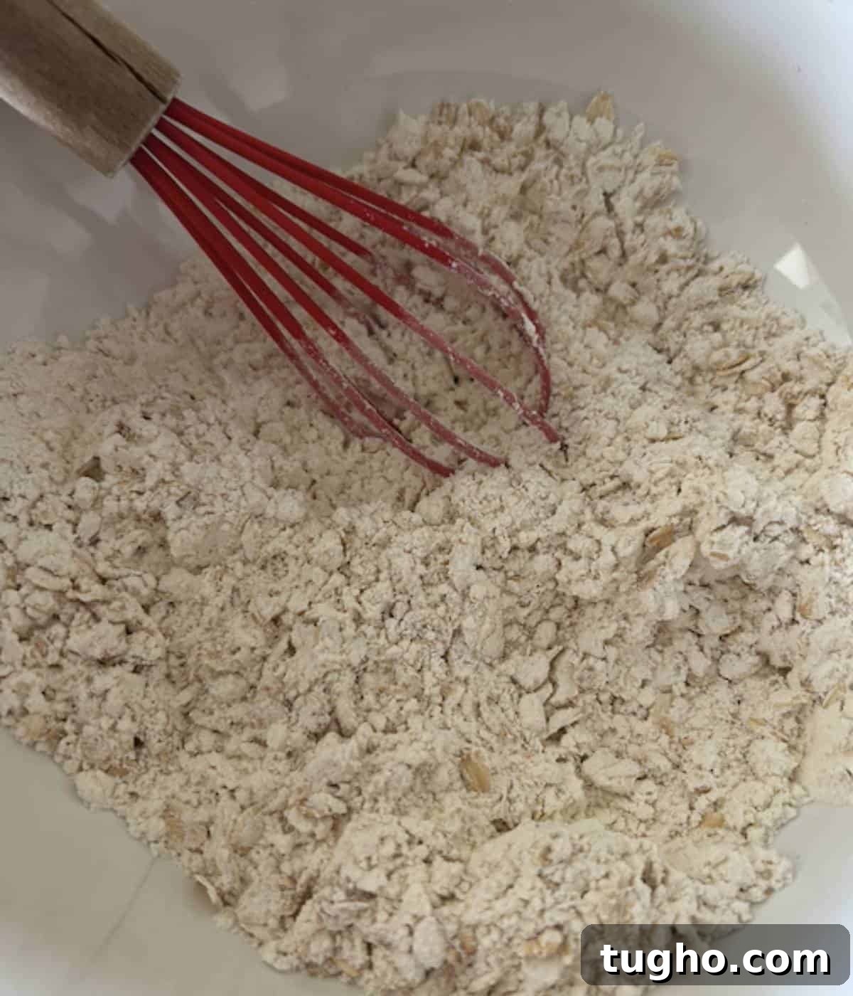 Dry ingredients in bowl with whisk.