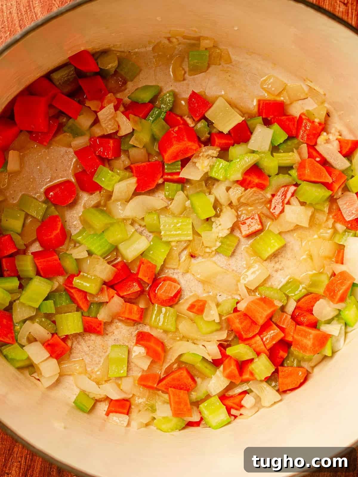 Nonna's Classic Italian Pasta Sauce Recipe 5 Dutch oven filled with diced and cooked onion, carrots and celery.
