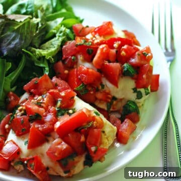 Grilled Chicken Topped with Fresh Tomato Bruschetta 4 Grilled Bruschetta Chicken served on a plate with salad.
