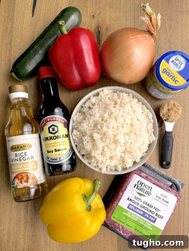 Beef and Pepper Rice Bowls 3 Close up view of ingredients on a wooden table for making an easy ground beef and bell pepper stir fry.
