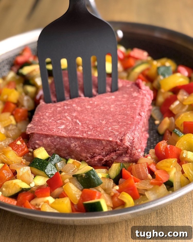 Beef and Pepper Rice Bowls 7 Large skillet filled with cooked bell peppers and onions with added raw ground beef for chopping and browning.