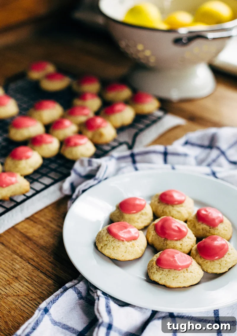 Zesty Lemon Buttermilk Cookies with Raspberry Glaze 7 lemon buttermilk cookies on a plate