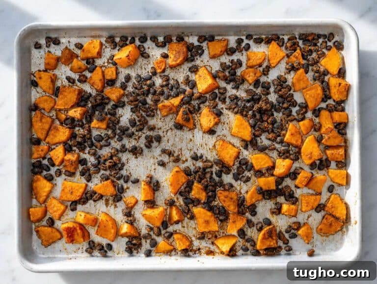 Step 1 Roasted sweet potatoes and black beans turning golden and slightly crisp in the oven.
