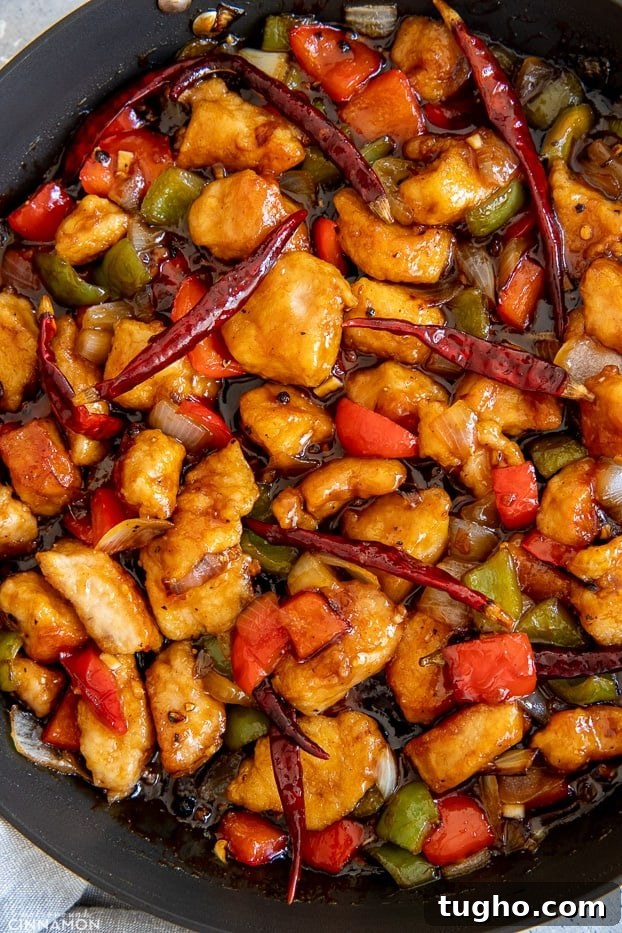 szechuan chicken Chinese Szechuan Chicken Stir Fry in a black skillet