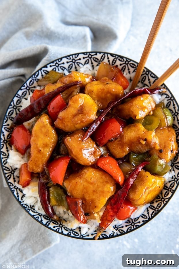 Szechuan chicken a bowl with Chinese Szechuan Chicken stir fry on rice with chopsticks
