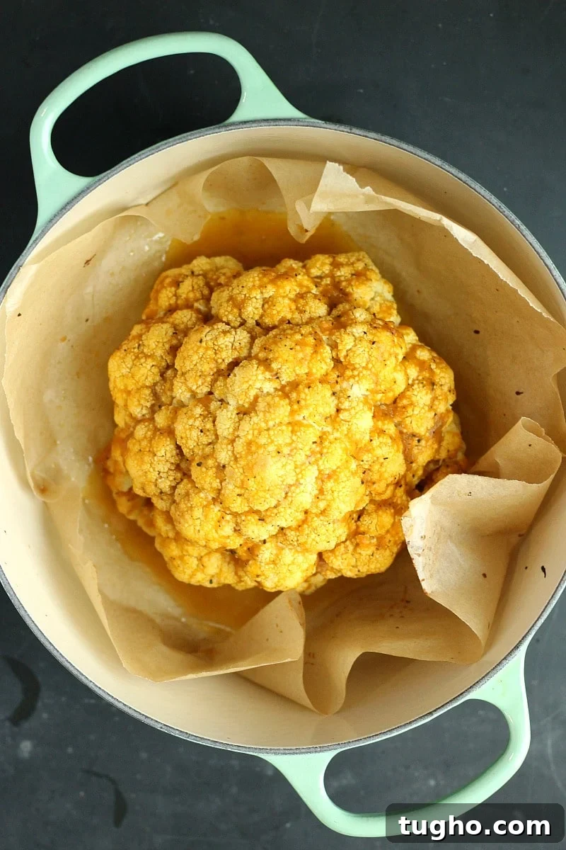 Crispy Pumpkin Spice Roasted Cauliflower Recipe 5 Cauliflower seasoned with pumpkin Spice and parchment paper in a pot.