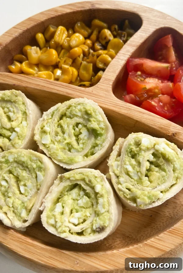 Avocado egg salad served with roasted corn and quartered grape tomatoes