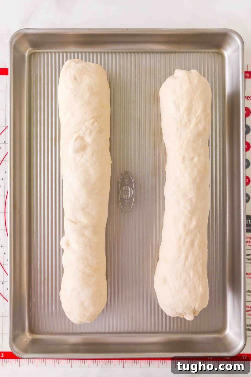 French Baguette Recipe: Make Two Loaves at Home 13 Shaped French Bread baguettes on a baking sheet for their second rise. Hostess At Heart