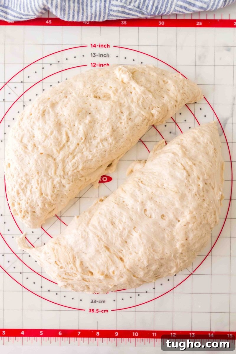 French Baguette Recipe: Make Two Loaves at Home 9 Homemade French bread dough separated into two pieces for shaping after the first rise. Hostess At Heart