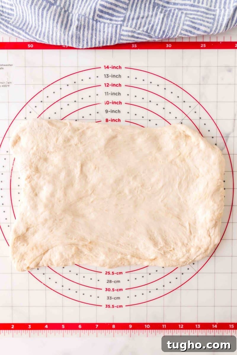 French Baguette Recipe: Make Two Loaves at Home 10 A rectangle of French bread dough before it's rolled into baguette log shapes – Hostess At Heart