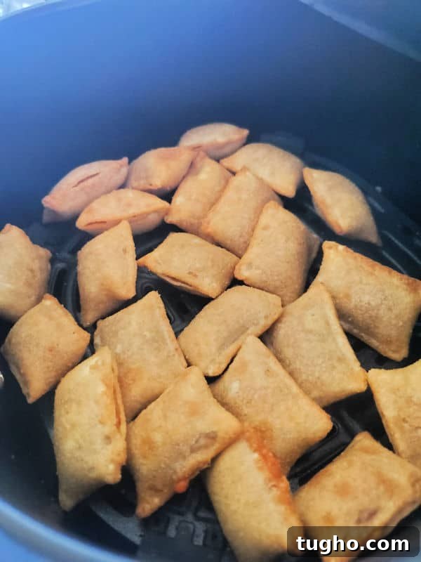 Crispy Air Fryer Pizza Rolls Recipe 6 Air fryer pizza rolls in the air fryer basket.