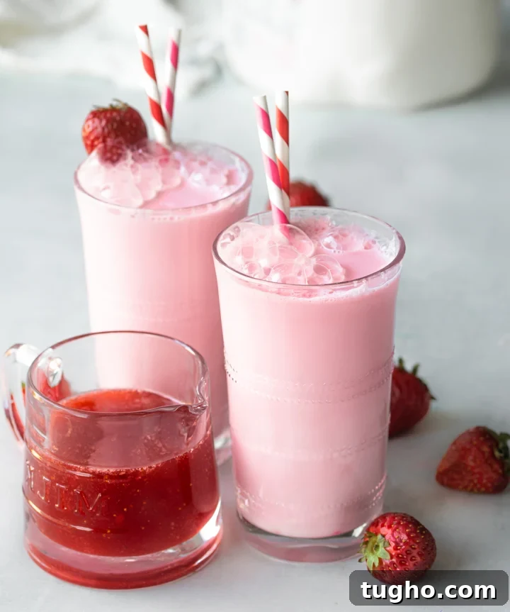 Homemade Strawberry Milk Recipe with Fresh Strawberries 2 Homemade strawberry milk with strawberry syrup in a glass with garnished with a strawberry