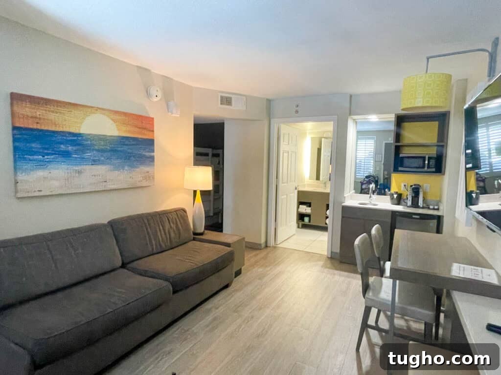 Holiday Inn Resort Orlando Suites with Onsite Water Park 5 living room, kitchenette and bathroom of the suite.