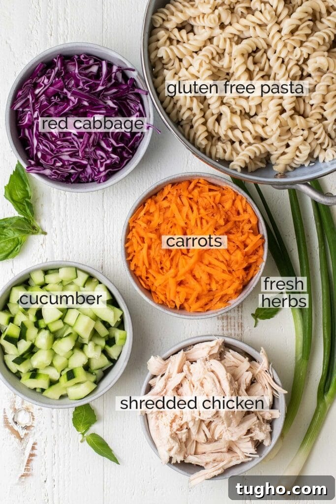 The veggies, chicken, and pasta needed to make this pasta salad.