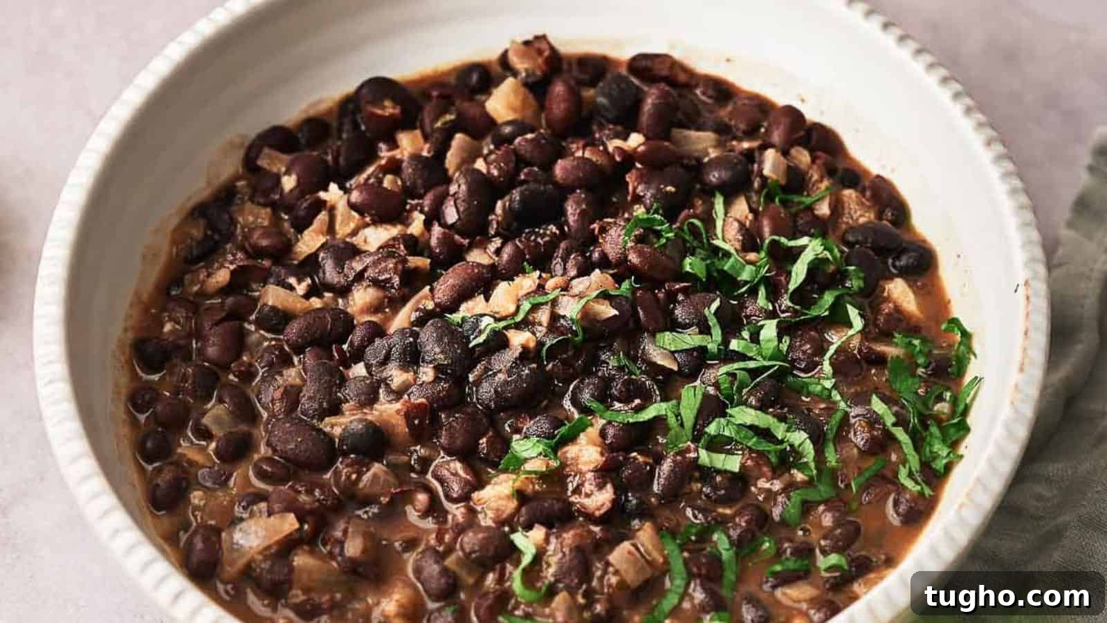 15 Copycat Recipes That Outshine Restaurant Meals 5 Chipotle black beans cooked and in a serving bowl.
