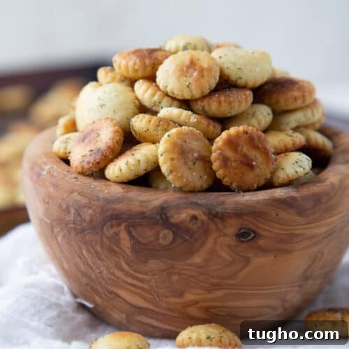 Oven-Baked Sweet and Spicy Chicken Wings Recipe 10 ranch oyster crackers in a wooden bowl.