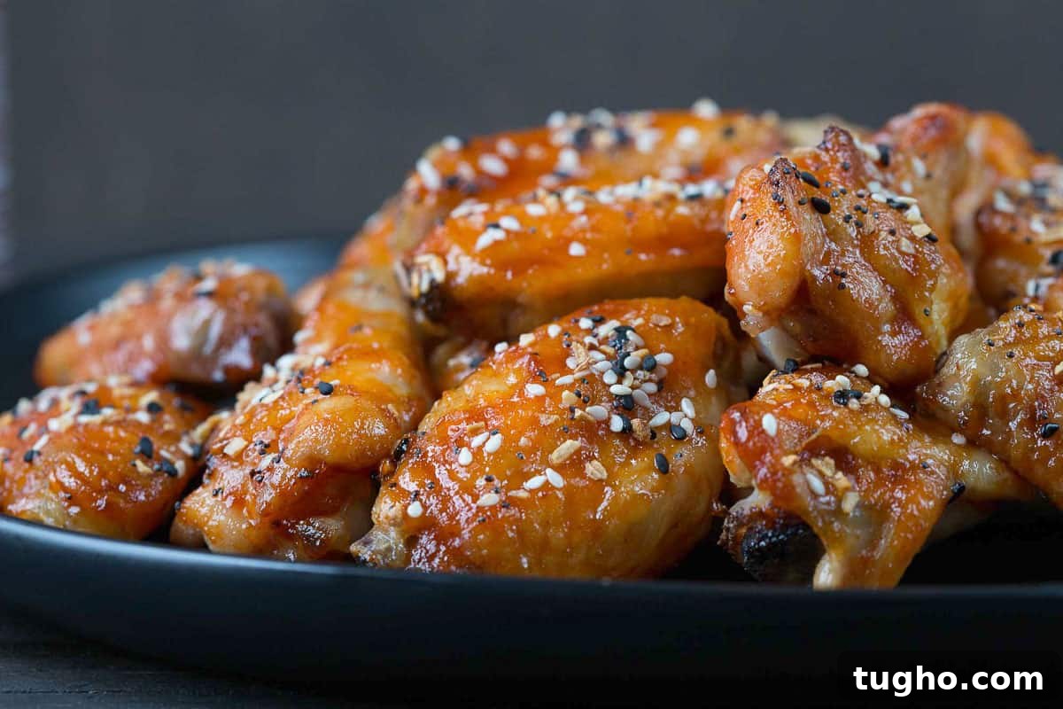 Oven-Baked Sweet and Spicy Chicken Wings Recipe 4 plate of sweet and spicy wings topped with everything bagel seasoning.