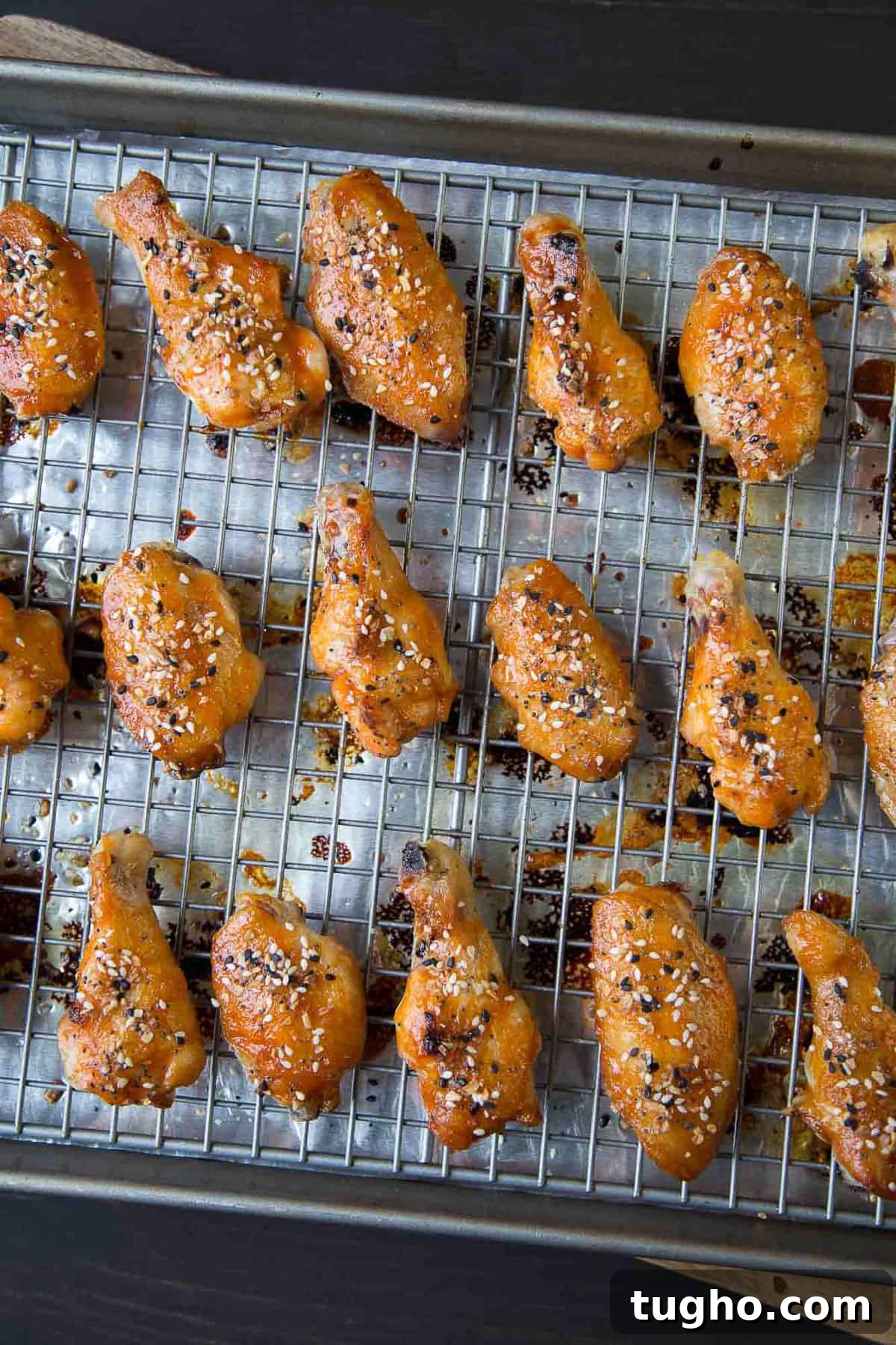 Oven-Baked Sweet and Spicy Chicken Wings Recipe 6 baked chicken wings on a wire rack.