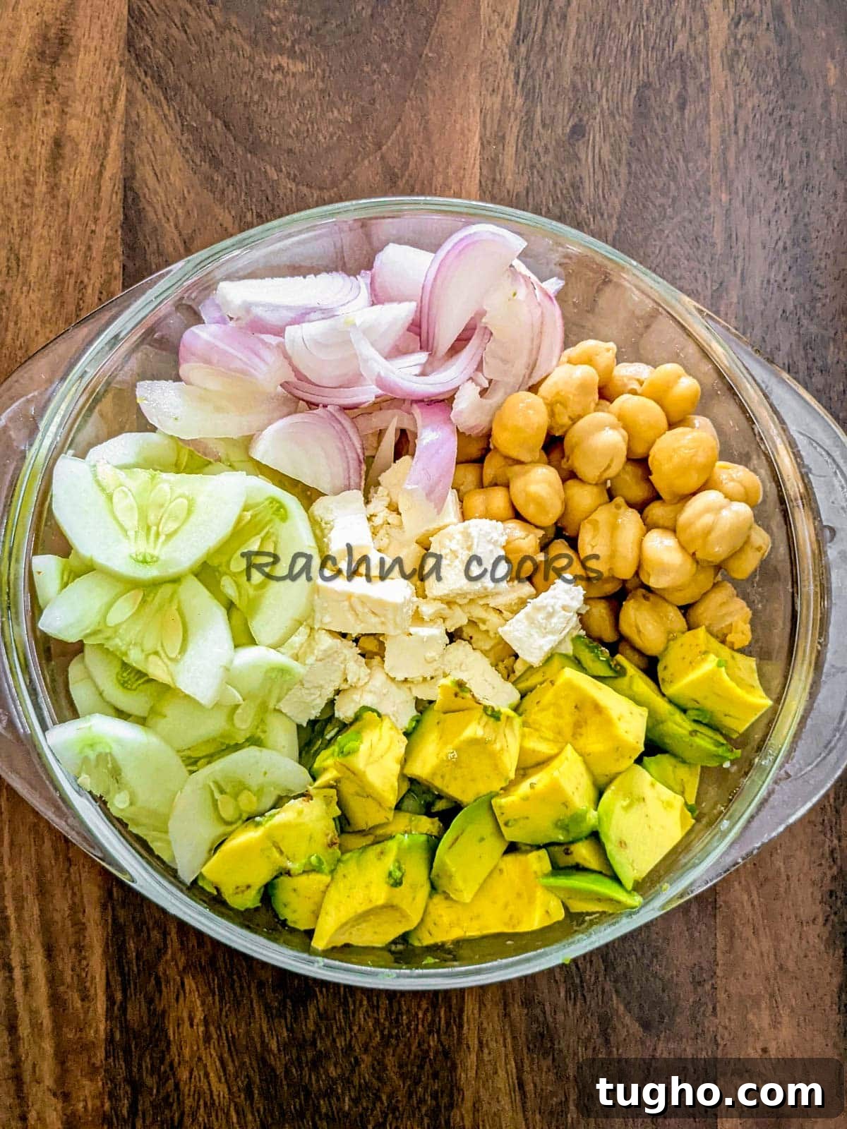 Zesty Chickpea and Cucumber Salad with Lemon Dressing 5 Cut avocado, cucumber, chickpeas, onion and feta assembled in a bowl.