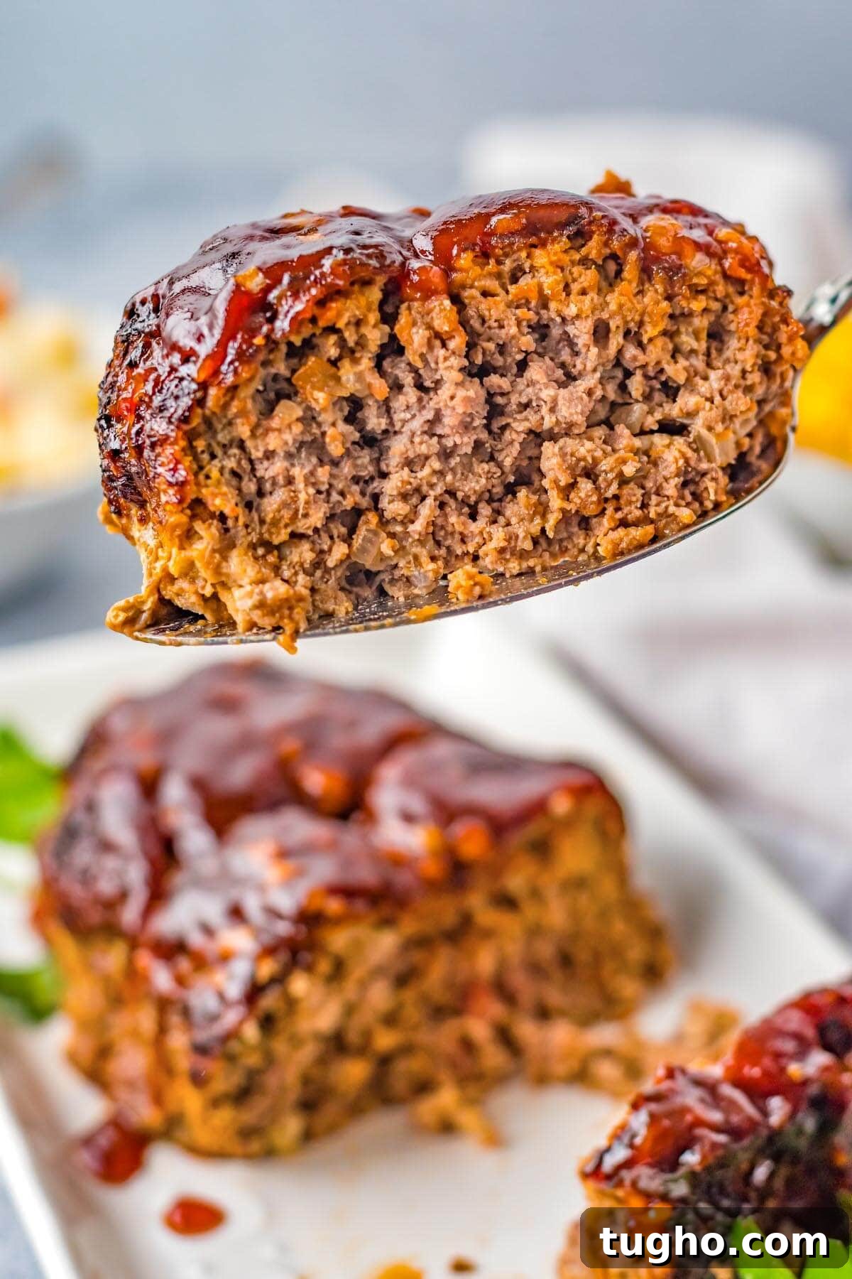 Juicy Air Fryer Meatloaf with Glaze 2 Air Fryer Meatloaf slice on a spatula