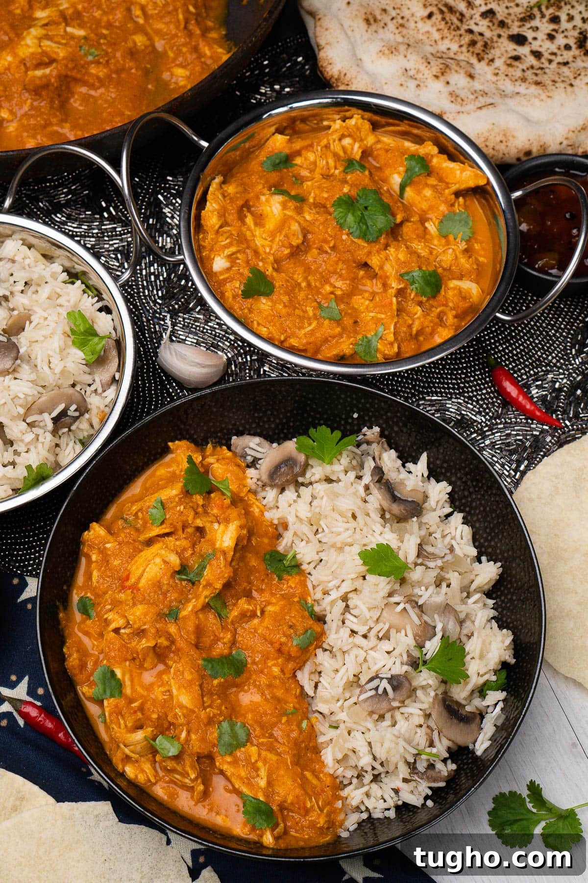 Leftover Turkey Curry with Coconut and Warm Spices 2 Leftover Turkey Curry in bowl and also in a silver Balti dish in the background