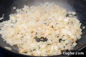 Leftover Turkey Curry with Coconut and Warm Spices 4 Chopped onions frying in a pan