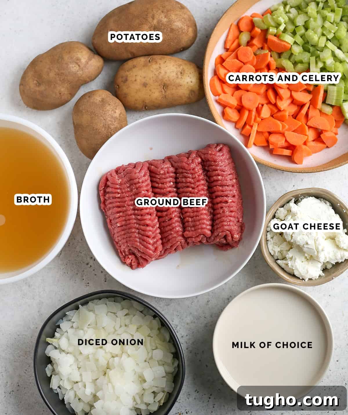 Creamy Cheeseburger Soup Recipe 3 All the ingredients of cheeseburger soup in individual bowls- ground beef, broth, onion, milk, goat cheese, carrots, celery and potatoes.