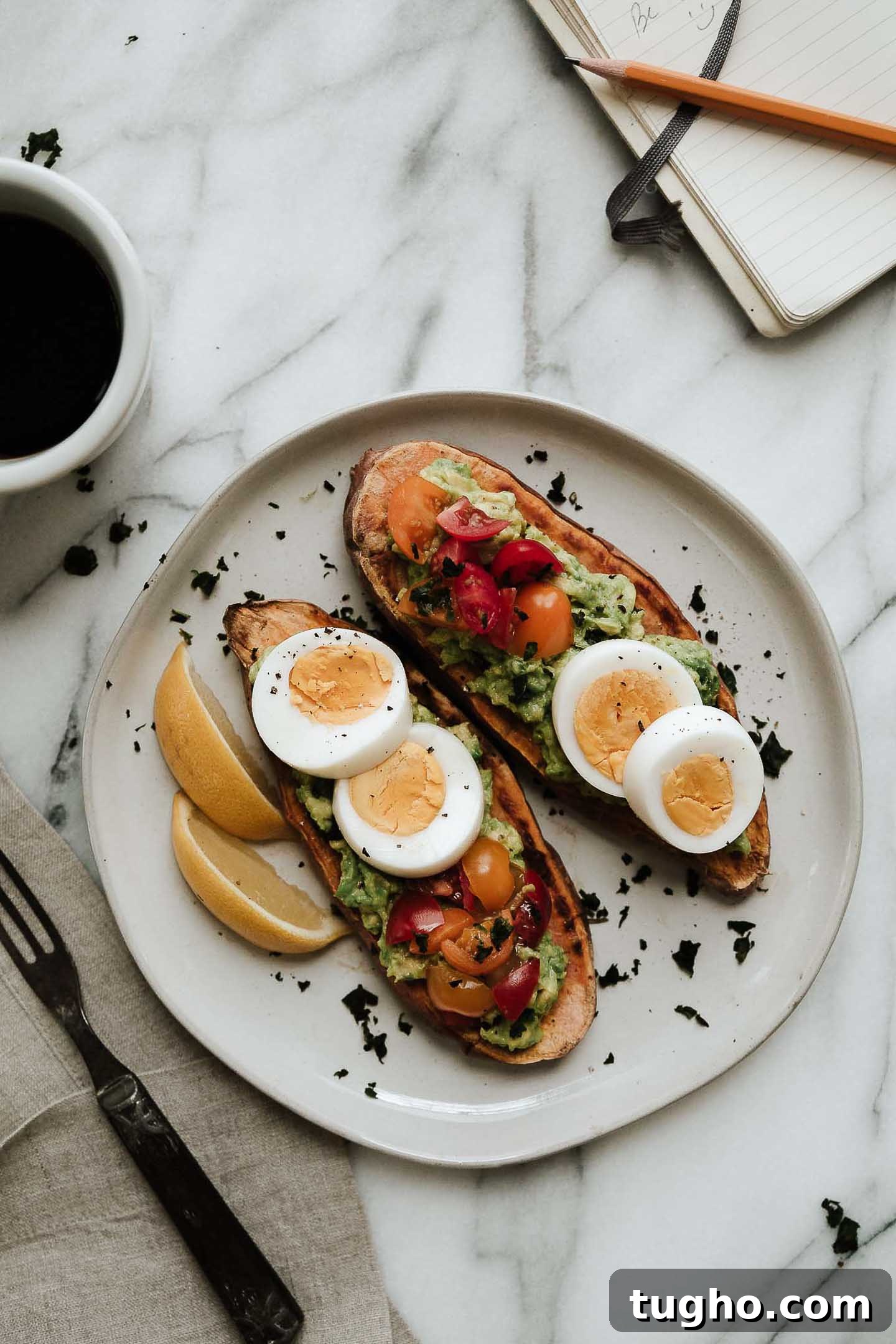 Sweet potato toast topped with eggs, tomatoes and avocado.