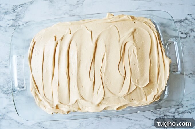 Spreading topping on butterscotch cake