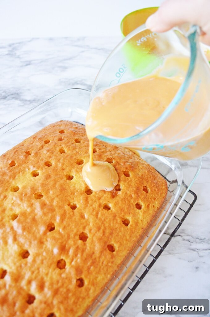 Butterscotch pudding poured over poke cake