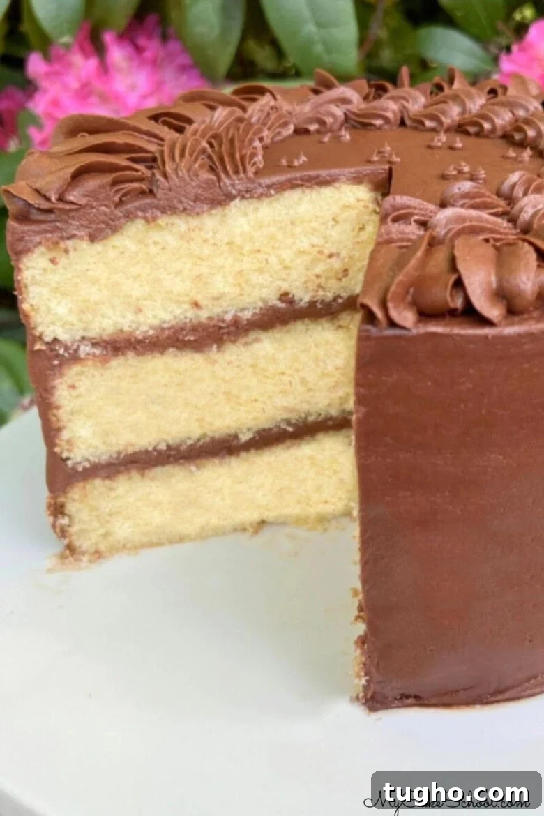 Yellow Birthday Cake, sliced, on a cake pedestal.