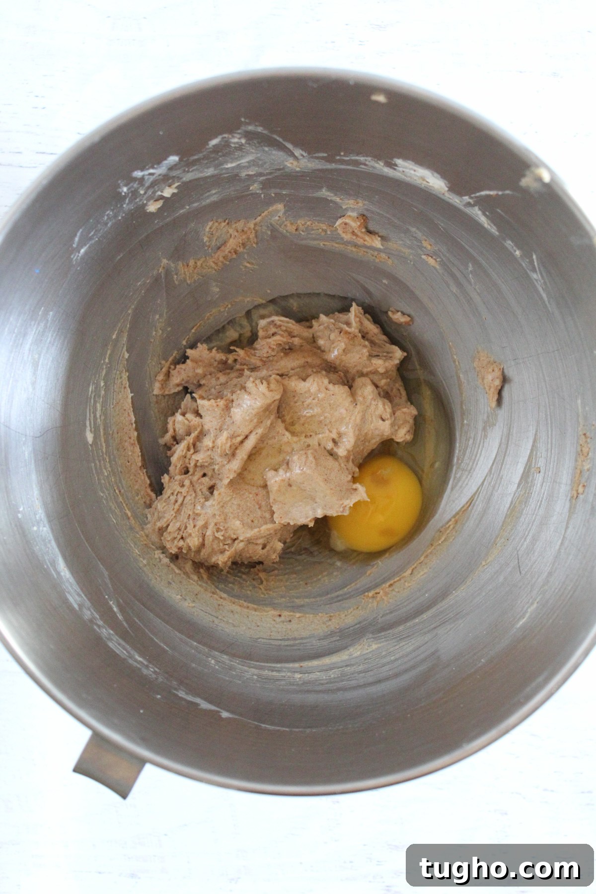 adding eggs to muffin batter