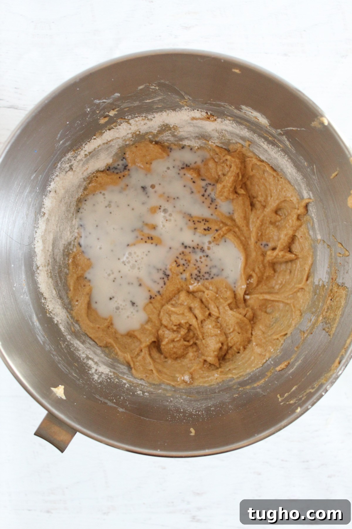 alternating flour in a mixing bowl