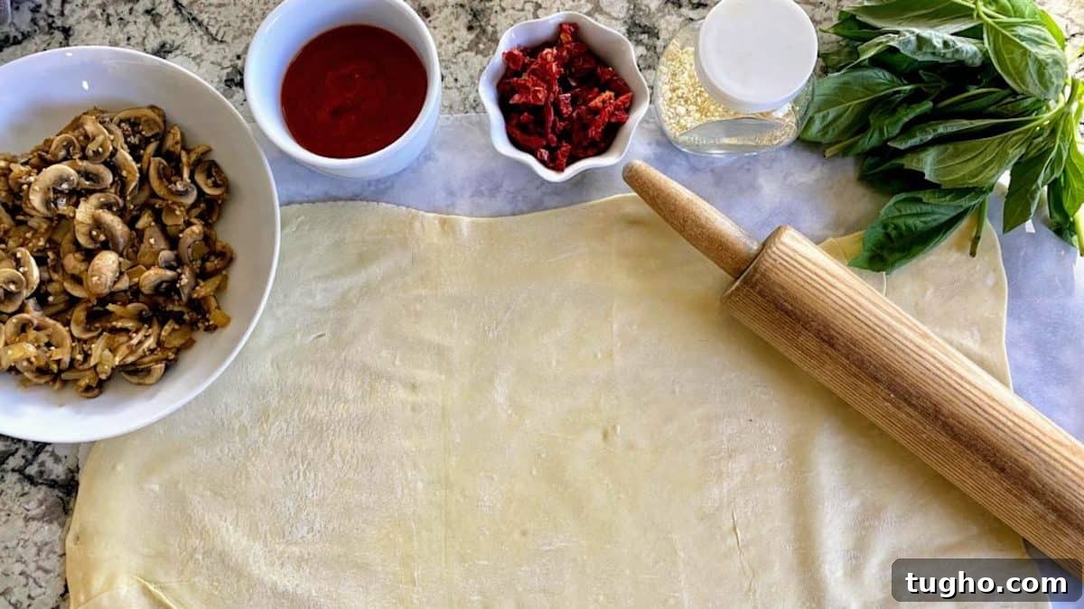 Vegan Pizza Pinwheels Recipe for Party Snacks 3 The rolled-out dough and vegan pizza pinwheel recipe ingredients are on the table.