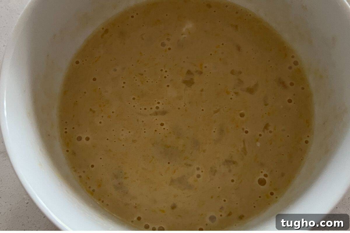 Moist Baked Chocolate Donuts Recipe 5 Wet ingredients for baked donuts in a bowl.