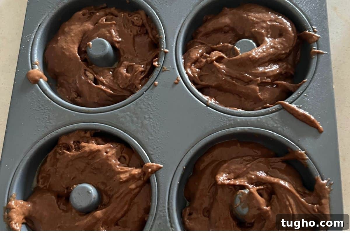 Moist Baked Chocolate Donuts Recipe 7 Baked chocolate donut batter in a donut pan.