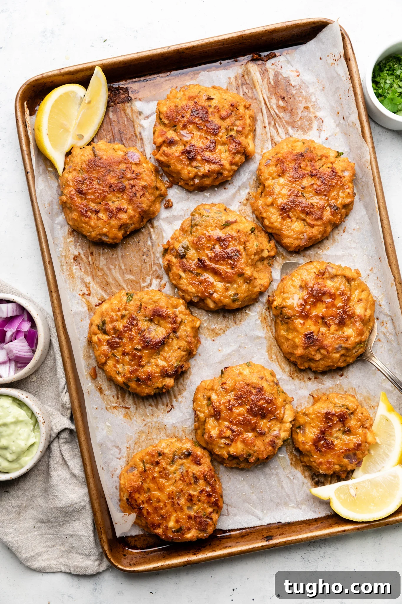 Baked salmon patties on a baking sheet