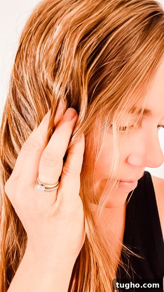 Scrunching hair with curl cream.